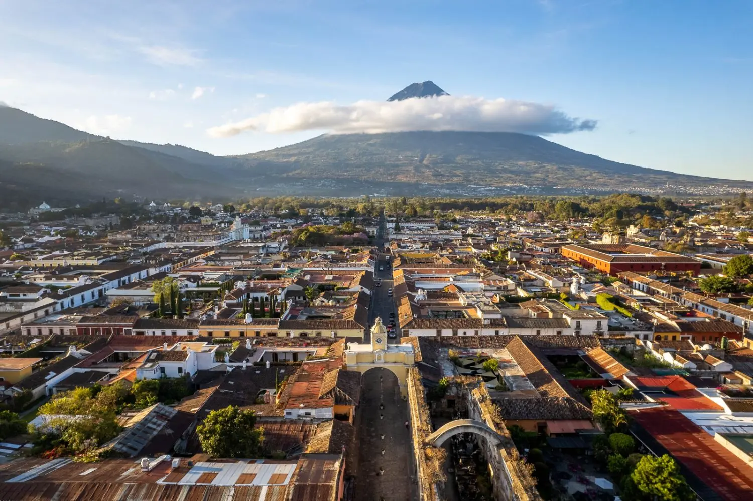 A cityscape view of the metropolis SR-Guatemala with urban neighborhoods, suburban streets and lush nature under a vibrant sky.