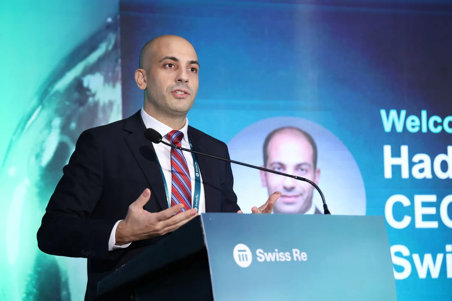 The speaker is presenting at the: "Shaping a sustainable future for India: How insurers can help" event.