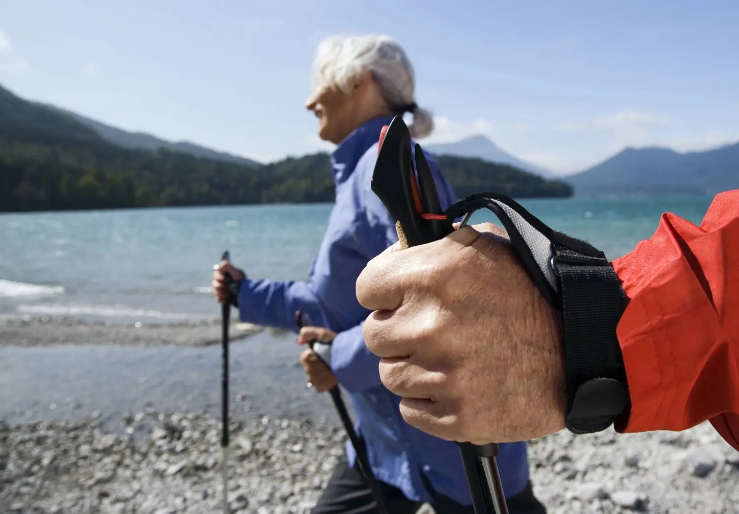 Active senior woman Nordic walking outdoors.