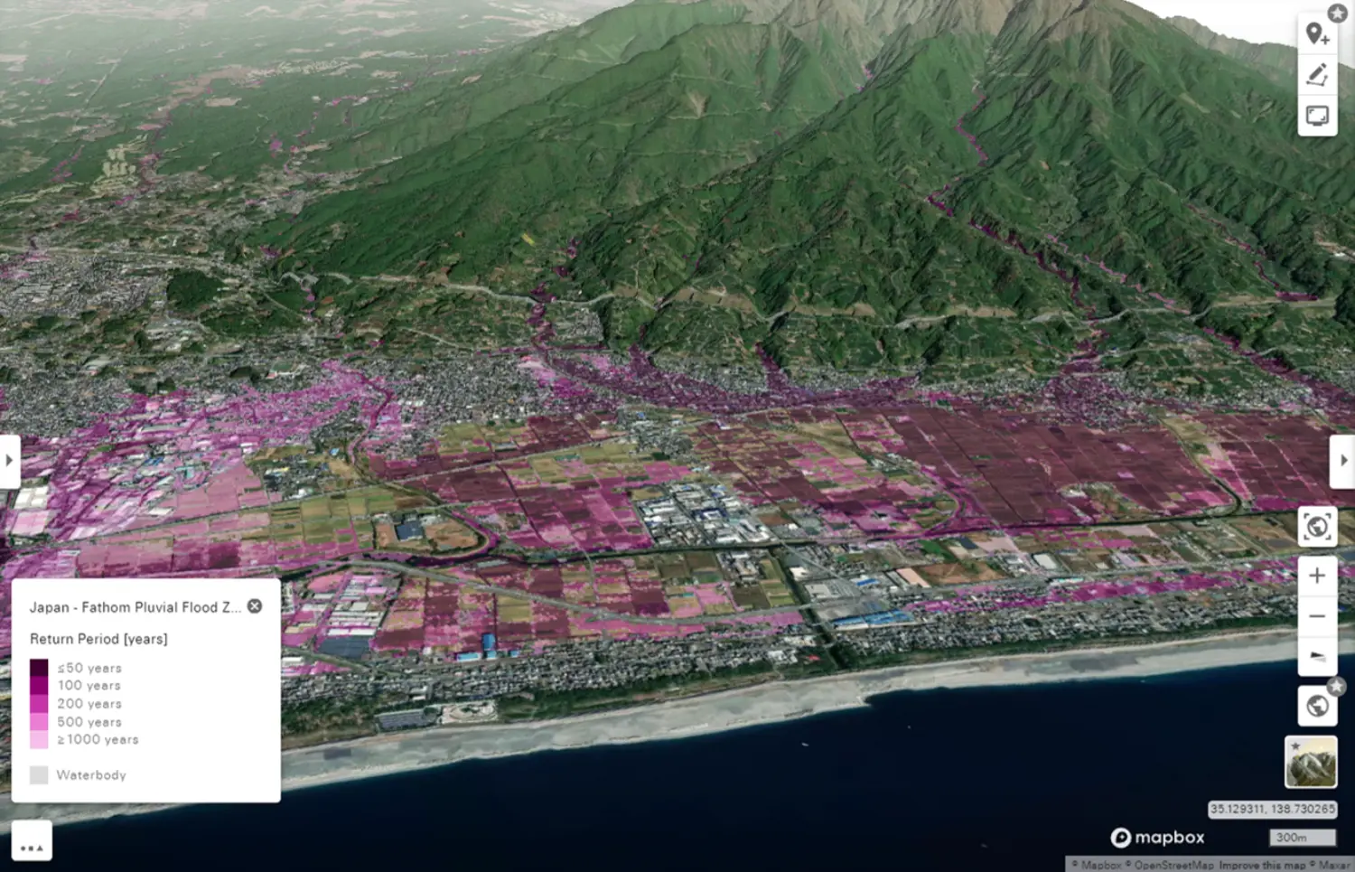 Aerial view of the serene Catnet neighborhood in Japan, highlighting its waterfront and scenic shoreline against the expansive sea.
