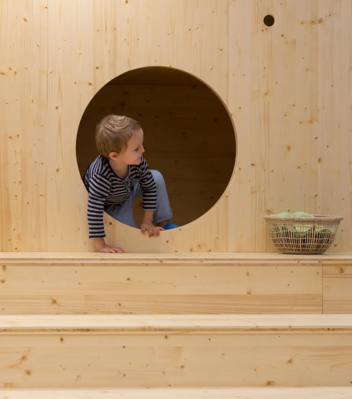 This a photo of a boy climbing in Kids House opened at Swiss Re.