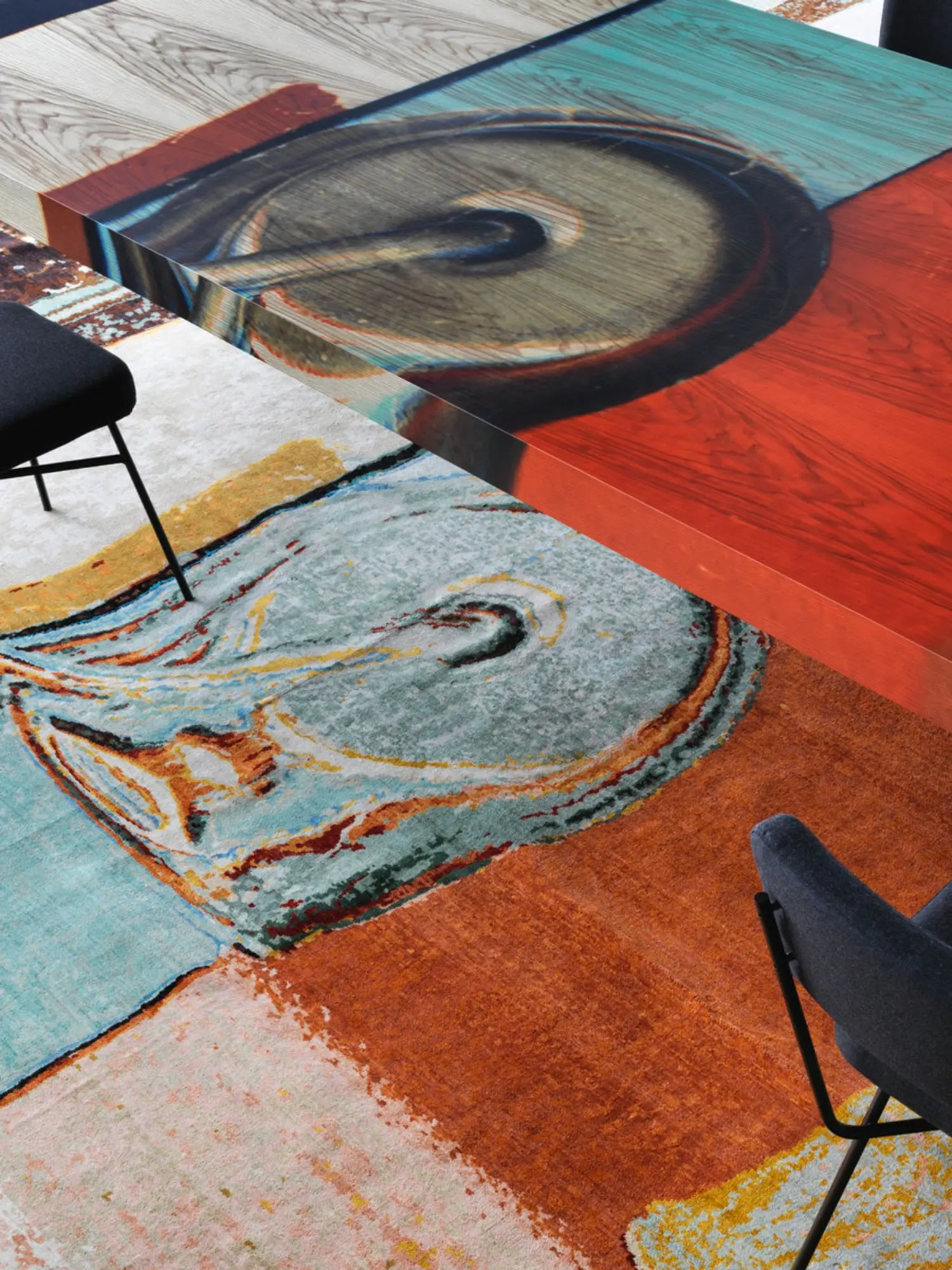 A table is a three-dimensional raised section of a picture. In this light, the picture not only superimposes itself over the rug like a skin, but actually covers the architecture itself and its furnishings.