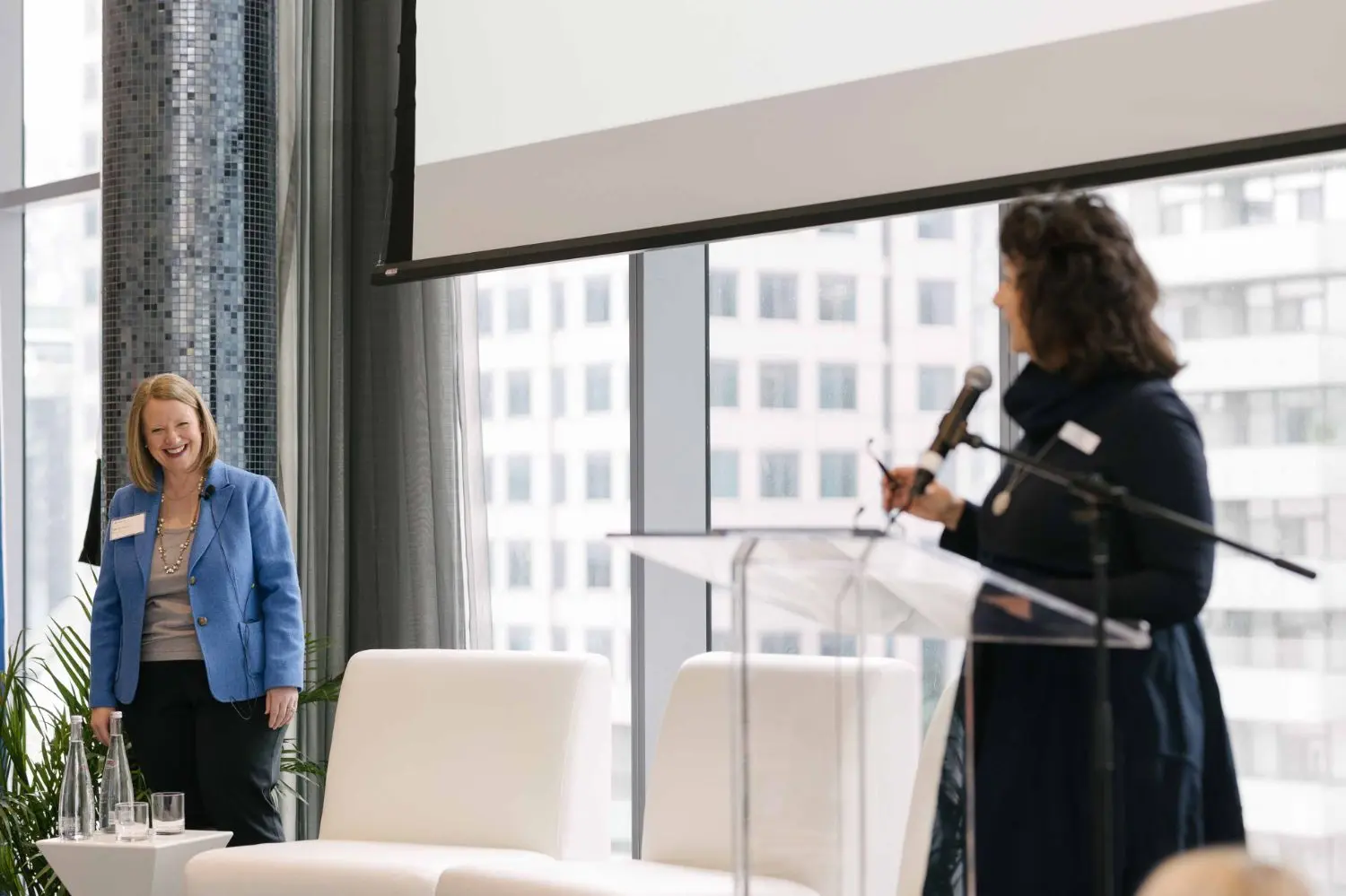 Photo from 37th annual Canadian Insurance Outlook Breakfast: women talking and laughing.