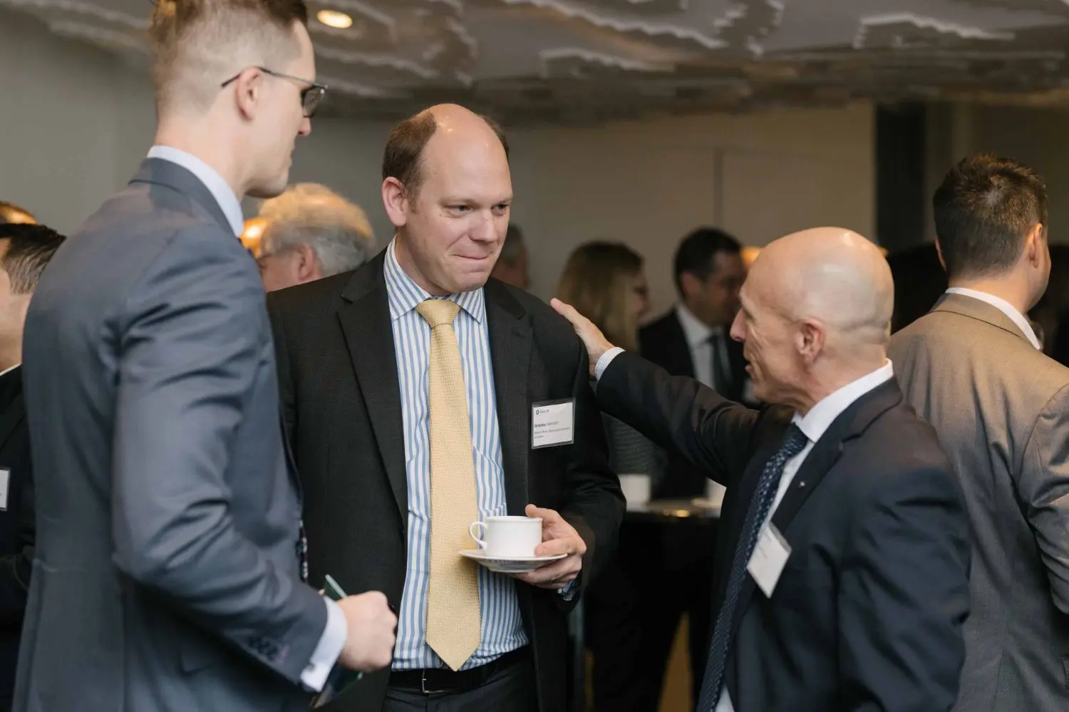 Photo from 37th annual Canadian Insurance Outlook Breakfast: people greeting.