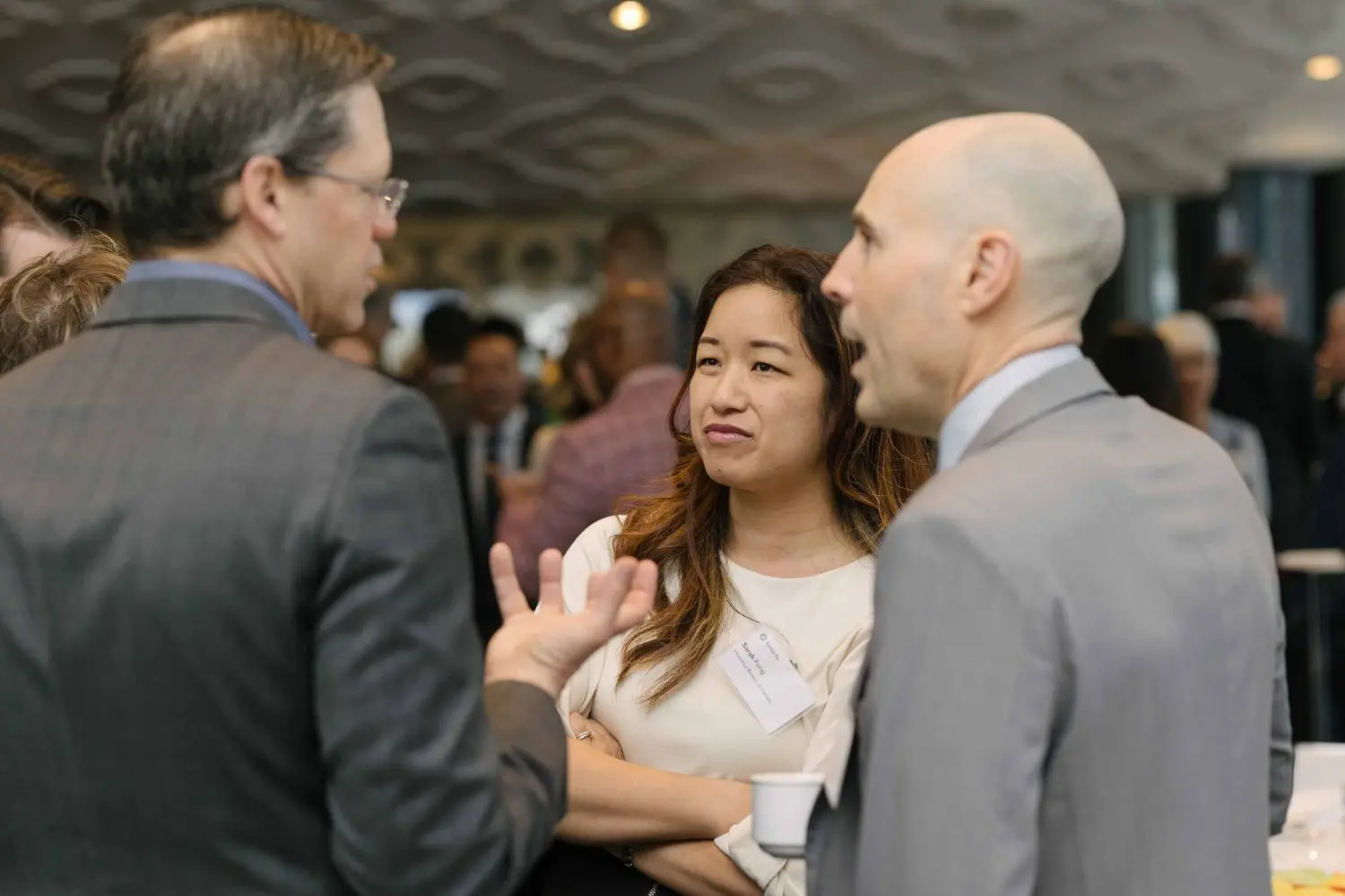 Photo from 37th annual Canadian Insurance Outlook Breakfast: people discussing.